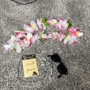 Miscellaneous group of charms, glasses, floral necklace, keychain, phone cord.